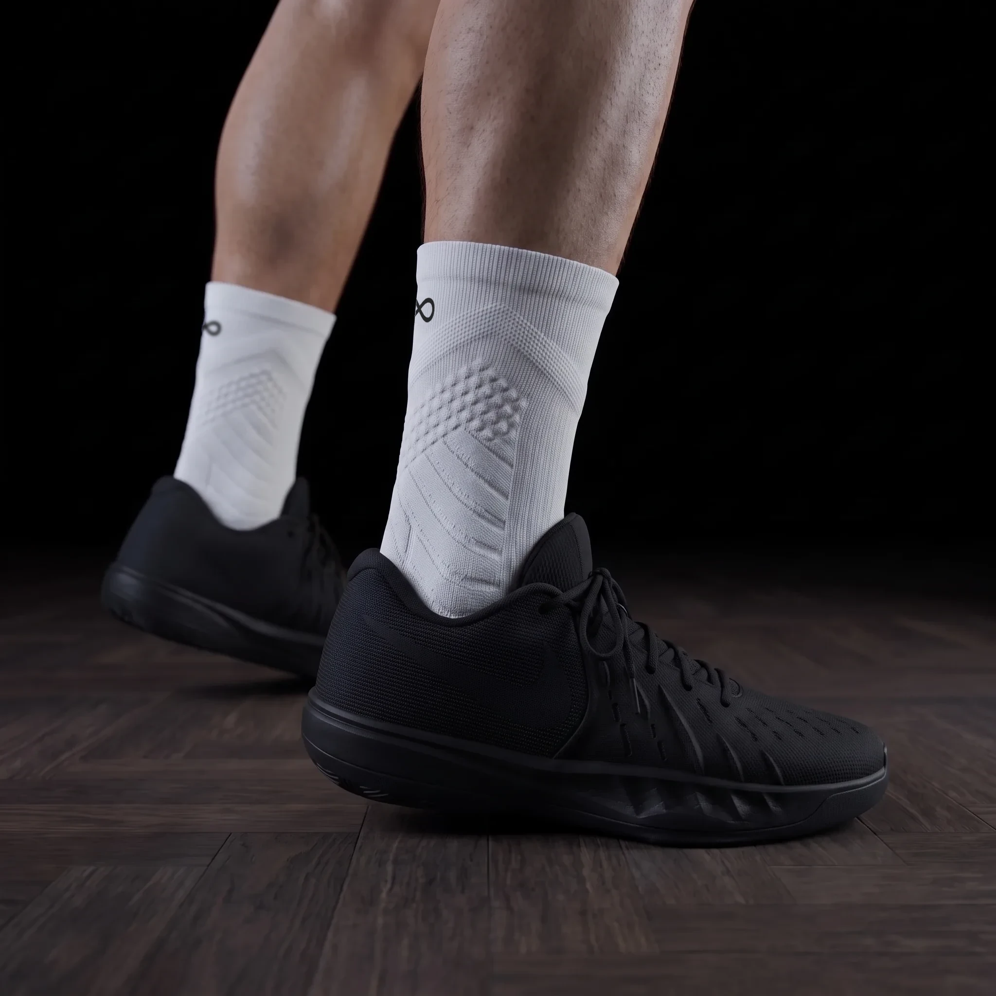 Infinity performance socks on court — the player's initials embroidered at the lateral ankle